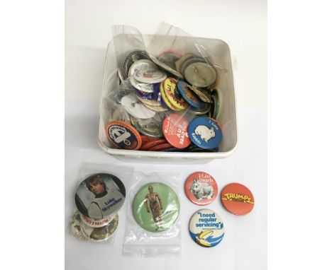A box of vintage badges including Star Wars