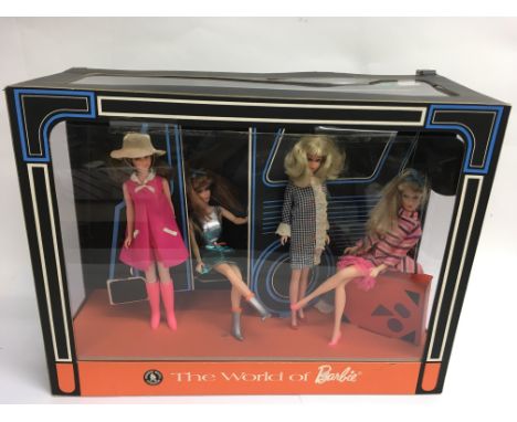 A rare Barbie promotional display case containing four vintage Barbie dolls on a tour bus  'The  World of Barbie' produced by