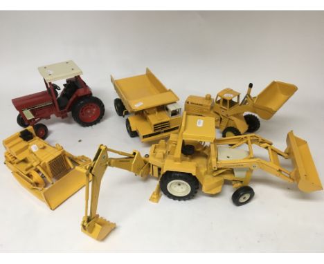 A collection of 5 diecast construction toys on a large scale,comprising of 4 Ertl models