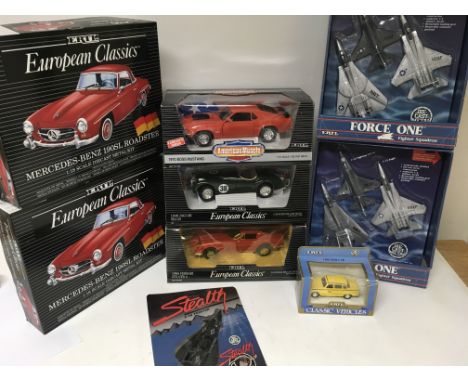 A collection of boxed Ertl diecast models and model kits