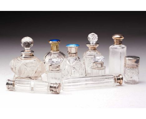 A collection of ten scent bottles including a London 1903 maker obscured, with prismatic cut stopper above a silver collar an