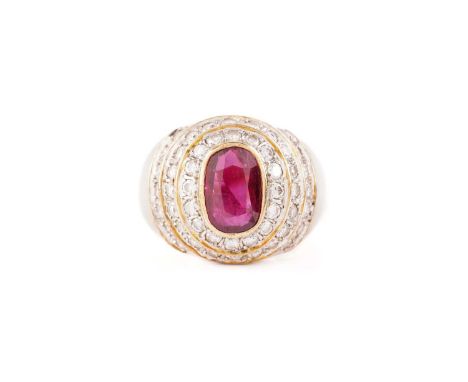 A ruby and diamond dress ring, containing an oval faceted ruby in dark purplish-red colour, approximately measuring 9.4 x 6.6