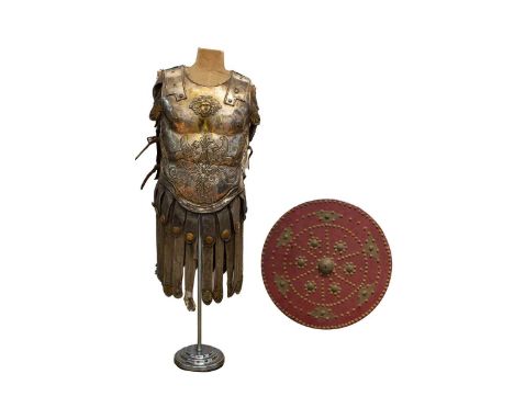 A partial suit of film prop Roman armour in beaten metal and hide. Comprising breastplate and back and skirt, reputedly produ