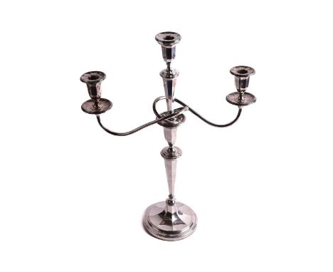 A George V silver three-branch candelabra, of tapering octagonal form, with detachable centre light and twin branches, on a c