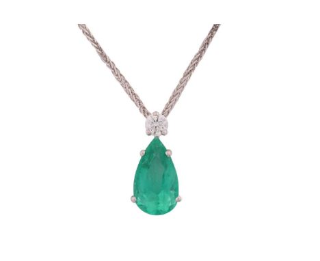 An emerald and diamond pendant on chain, featuring a pear-cut emerald with bright green body colour, approximately measures 1