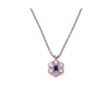 A sapphire and diamond cluster pendant on chain, the round mixed cut sapphire, rub over set, approximately 0.46ct, surrounded