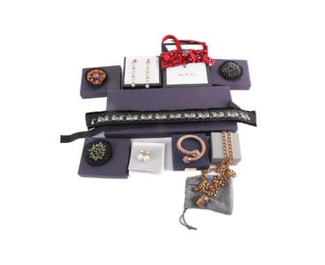 A collection of branded fashion accessories; to include three Prada beaded brooches, and a rhinestone and velvet belt;a Gucci