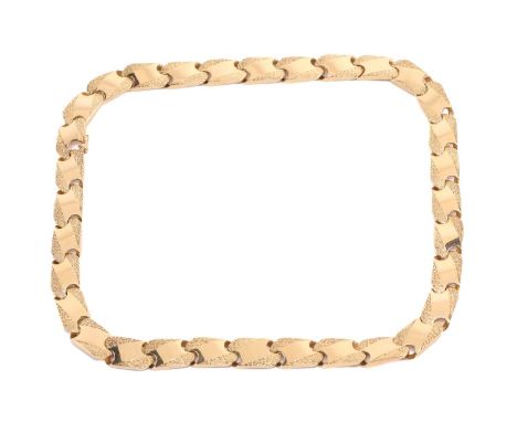A fancy curb link chain, panels part textured, finished with a figure-of-eight clasp, yellow metal marked '750', length measu