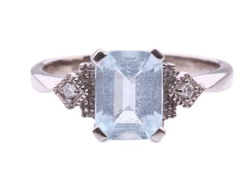 An aquamarine and diamond dress ring in 18ct white gold, comprising an emerald-cut pale blue aquamarine of 7.6 x 5.9 x 2.9 mm