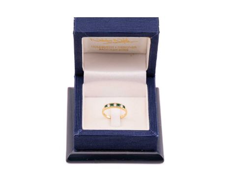 An emerald and diamond pendant necklace and an emerald and diamond ring set in 18ct gold, the ring channel set with four roun