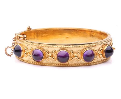 A Late Victorian five-stone amethyst hinged bangle, comprising five high-domed amethyst cabochons in closed-back collets, fla