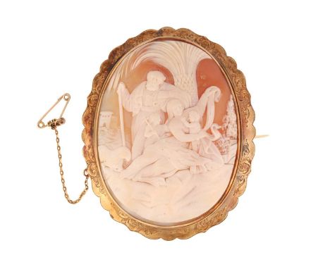 A large Victorian shell cameo brooch with a biblical scene, depicting The Holy Family in a landscape seated under a palm tree