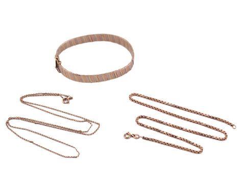 A 9ct gold hinged bangle and two necklaces; the bangle comprises of band wrapped with diagonal gold stripes in alternating co