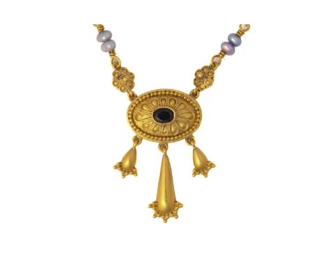 An Etruscan revival necklace with a central rub over set oval sapphire in a yellow metal stamped 22ct rosette measuring 19mm 