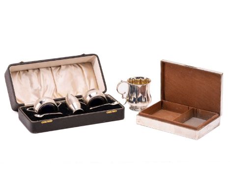 A silver Christening mug, an engine-turned cigarette box and a cased five piece condiment set.