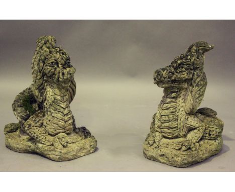 A pair of 20th century cast composition stone garden models of recumbent dragons, height 46cm, width 38cm.Buyer’s Premium 29.