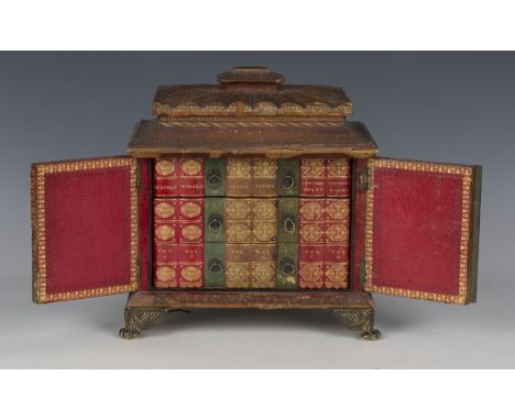 A late George III red gilt-tooled leather table-top writing cabinet, the pagoda top with hinged lid above two doors opening t