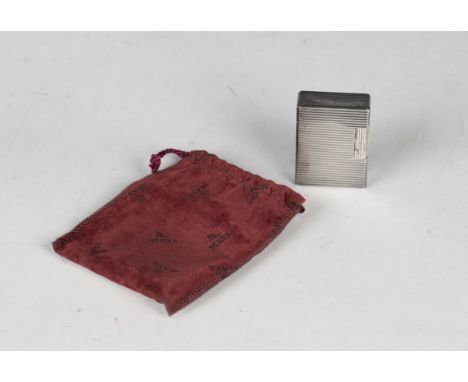 A Dupont Paris rectangular cased gas lighter, with ridged decoration, length 4.8cm, with a red pouch.Buyer’s Premium 29.4% (i