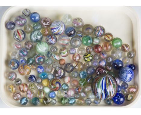 A collection of 19th and 20th century glass marbles, including German latticino examples and a large coloured swirl marble, d
