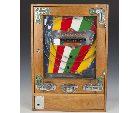 A Bryans Elevenses oak cased penny slot machine with chromium plated mounts and polychrome striped celluloid back panel, 63cm