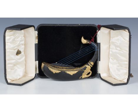 A late 19th/early 20th century Burmese black lacquered and gilt decorated saung (harp) of typical boat shaped form, length 23