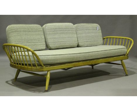 An Ercol elm daybed with panel back and hoop ends, height 76cm, width 210cm, depth 80cm.Buyer’s Premium 29.4% (including VAT 