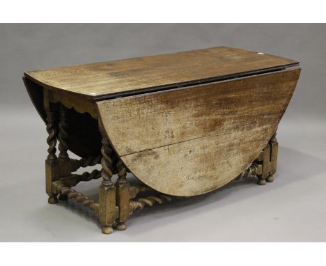 A large 18th century style oak oval gateleg table, raised on barley twist and block legs, height 70cm, width 180cm, depth 151