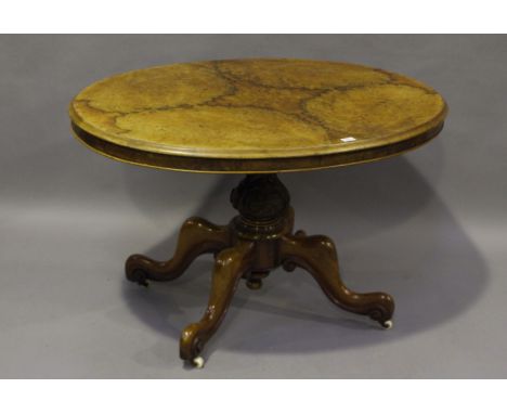 A small mid-Victorian burr walnut oval tip-top breakfast table, raised on a carved baluster stem and four cabriole legs, heig