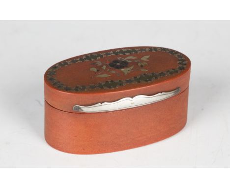 A George III red papier-mâché oval snuff box, the lid inlaid in various metals with flowers and foliage, length 9.2cm.Buyer’s