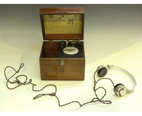 A Cosmos radiophone crystal set, within a mahogany case, width 21.5cm.Buyer’s Premium 29.4% (including VAT @ 20%) of the hamm
