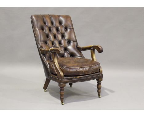 A 20th century Victorian style buttoned brown leather library armchair, raised on turned legs and castors, height 93cm, width