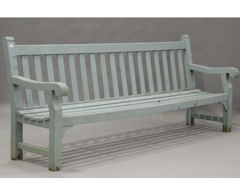 A large 20th century green painted wooden garden bench with slatted seat, height 96cm, length 243cm, depth 70cm.Buyer’s Premi