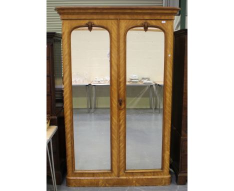 A Victorian satin walnut wardrobe, the two mirrored doors enclosing drawers and trays, height 206cm, width 138cm, depth 64cm 