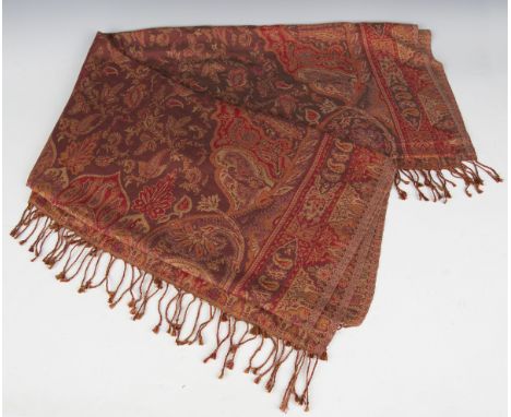 A large woven wool Paisley shawl, worked with a central field of scrolling tendrils and boteh within elongated boteh borders,