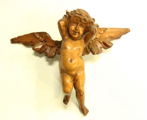 A late 19th century Continental carved pine model of a cherub, width 27cm.Buyer’s Premium 29.4% (including VAT @ 20%) of the 
