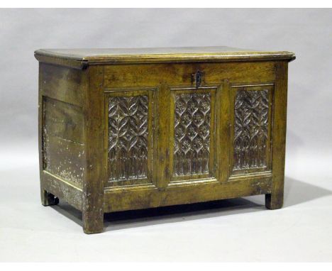 A 17th century oak coffer, the hinged lid above three carved tracery panels, height 64cm, width 91cm, depth 50cm (some altera