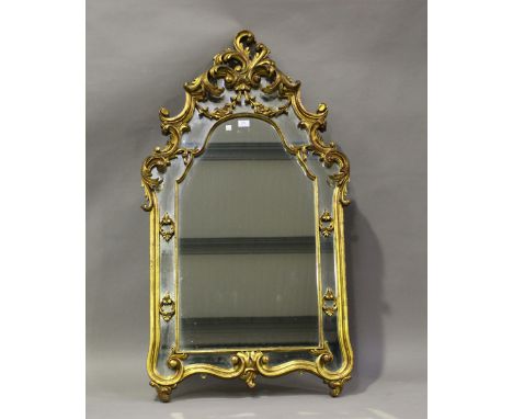A 20th century rococo style giltwood wall mirror, 132cm x 71cm.Buyer’s Premium 29.4% (including VAT @ 20%) of the hammer pric