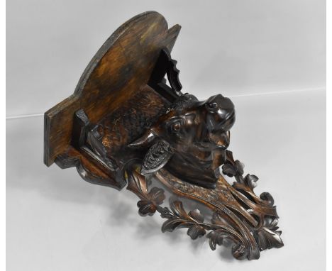 An Early 20th Century Carved Black Forest Wall Shelf with Bulls Head, Pierced Back Plate, 28cms Wide and 34cms High