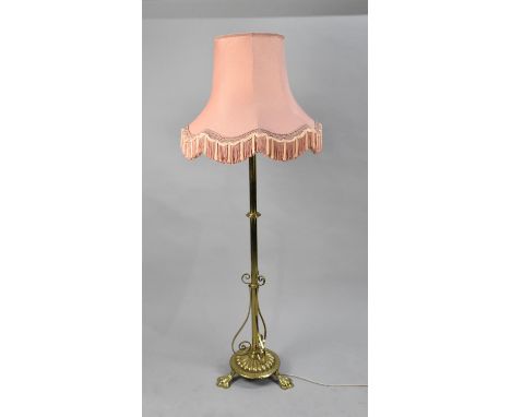A Mid 20th Century Heavy Brass Standard Lamp having Turned Support and Three Claw Feet, Complete with Shade