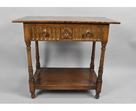 A Mid 20th century Oak Side Table with Single Carved Drawer and Turned Supports, Stretcher Shelf, 84x43x75cms High