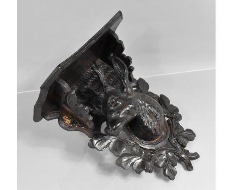 A Vintage Carved Black Forest Wall Sconce/Shelf. 29cms Wide and 34cms High with Stags Head Decoration