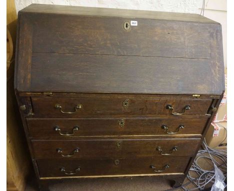 A Georgian Oak Writing Bureau, Having a fall front enclosing fitted drawers and pigeon holes, above four long drawers, raised