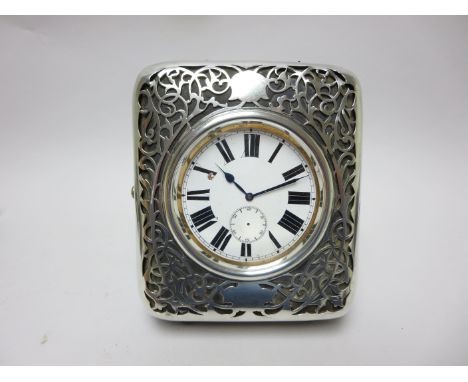 An Edward VII silver overlaid Travelling Clock Case with pierced design, London 1902, containing a mammoth nickel plated Pock