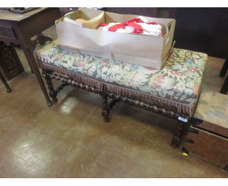 An oak Jacobean style Window Stool, the tapestry stuff over seat above six barley sugar turned legs and stretchers, 3ft 5in W