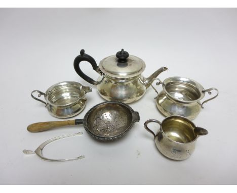 A George V Bachelor’s silver three piece Tea Service of circular form, London 1912, a small Jug, London 1887, a pair of wishb