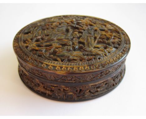 A Chinese carved tortoiseshell circular Snuff Box depicting Sages in a landscape, 3in, A/F