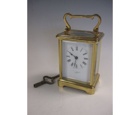 A French Carriage Clock in brass case with swing carrying handles, white enamel dial marked, Mash Paris, 4 1/2in H