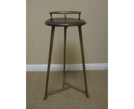 A Ship’s Table with brass gallery to the circular top, the brass tripod base with twist detail, 2ft 5in H