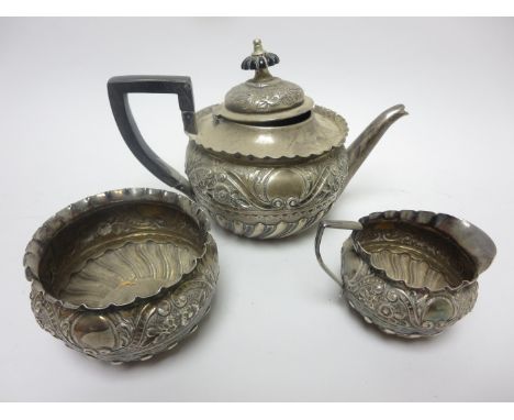 A Victorian silver three piece Tea Service of circular form floral and scroll embossed, London 1889