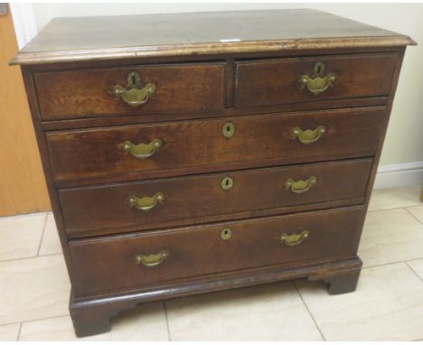 An antique oak Chest of two short and three long drawers on bracket feet, 3ft 2in W
